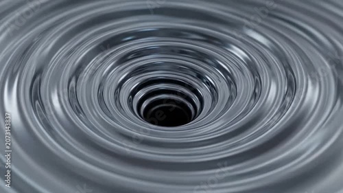 Metallic liquid vortex swirling into a dark central hole