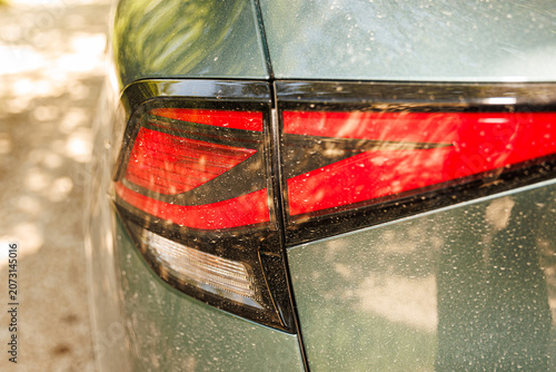 Car detail covered in fine desert sand layer, saharian dust storm and extreme weather climate concept