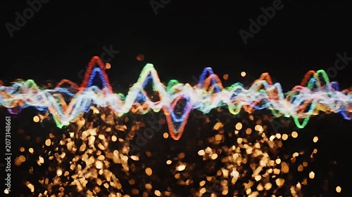 Colorful light wave with golden sparks below.