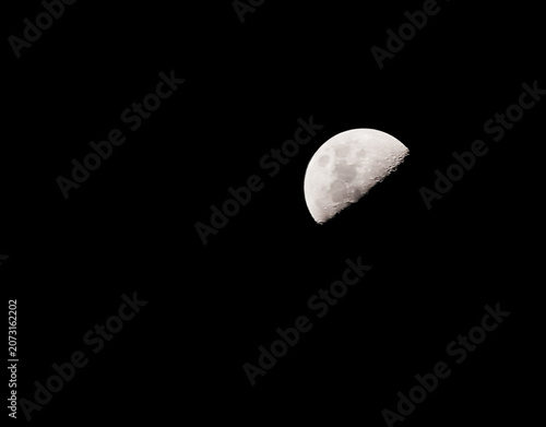landscape view of a half moon in the dark night sky