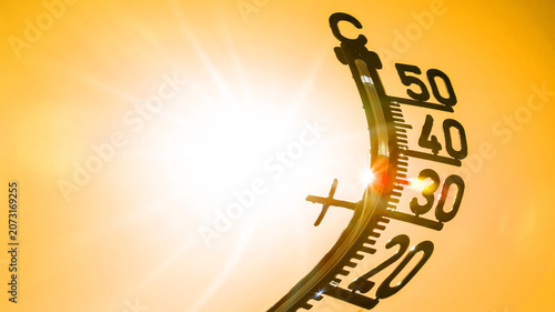 Hot weather - Heat wave / Summer heat background - Thermometer yellow orange sky and sun rays