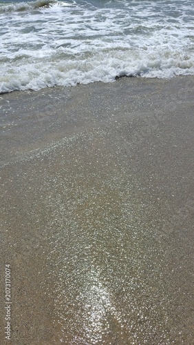 waves on a pristine coastal sandy beach
