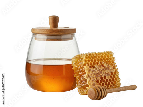 Golden liquid honey in a glass jar with honeycomb and dipper during bright studio lighting isolated on transparent background