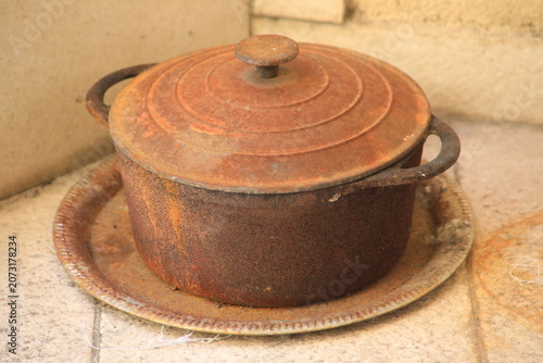 Corroded, antique cast iron pot