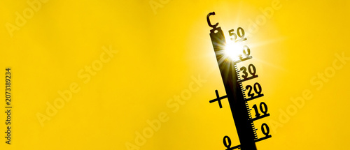 Hot weather, global climate change concept - Heat wave / Summer heat temperature celsius background banner long - Thermometer yellow orange sky and sun rays