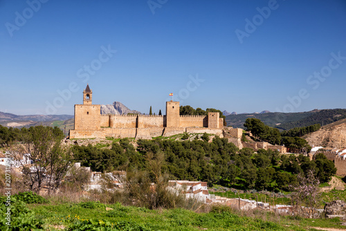 View of the Alcazaba fortress of Antequera against a mountainous backdrop. Spain, Andalusia, Malaga Province