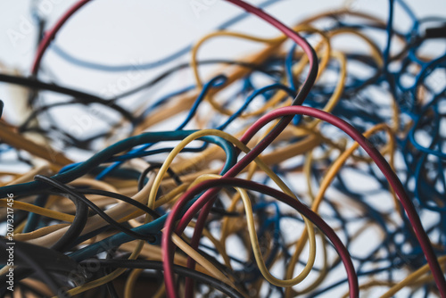 Foto Old tangled ball of colorful electric wires and cables on a white background