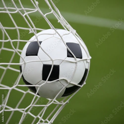 Soccer Ball Caught in Goal Net Mesh After Scoring Point with Blurred Green Field Background - Created with Generative AI