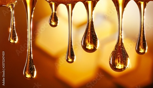 golden honey droplets dripping and falling in macro close up