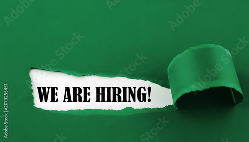 We Are Hiring Message Revealed Through Torn Green Paper For Recruitment Career Opportunity And Human Resources Concept