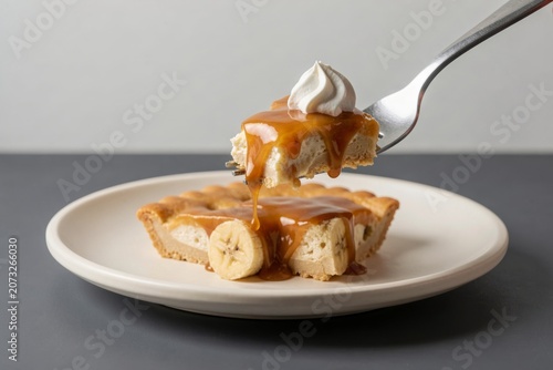 Banoffee Pie topped with whipped cream and caramel sauce, alongside slice of banana caramel cream pie with biscuit. Concept of dessert indulgence and sweet treats.