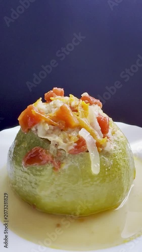 Zucchini stuffed with meat and rice, stewed in tomato sauce. Delicious and healthy home cooking.