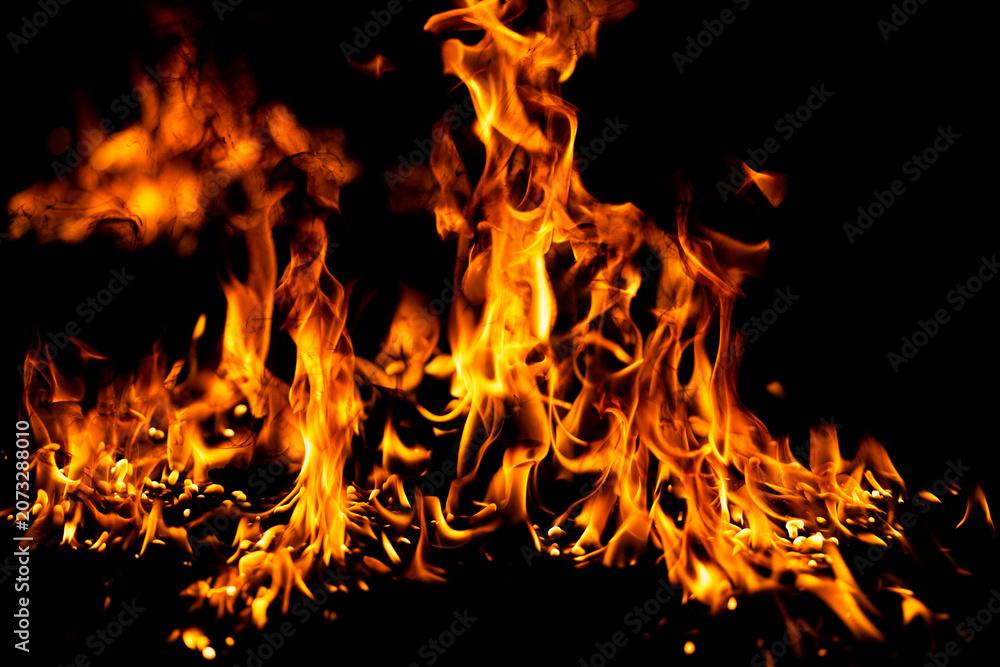 Fototapeta premium Flame glows above orange flames. Flame frames bright flames. Realistic flame with fire. Burning flame beside fire.