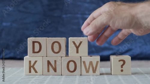 motivational phrase do you know ?, laying out  by hand from letters on wooden cubes, slow motion

