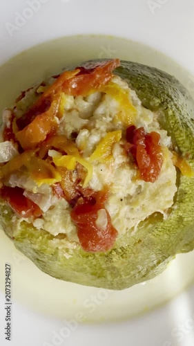 Zucchini stuffed with meat and rice, stewed in tomato sauce. Delicious and healthy home cooking.