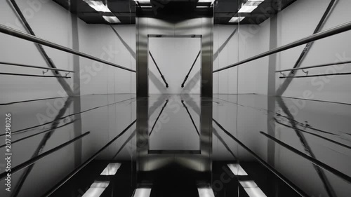 Modern Futuristic Elevator Interior with Reflective Surfaces and Geometric Design.