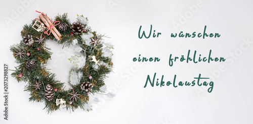 Christmas wreath adorned with pine cones, cinnamon sticks, and decorative elements, creating a festive atmosphere for holiday celebrations and New Year festivities