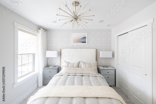 Serene White Bedroom with Chevron Dresser, Round Mirror and Fluffy White Bedding