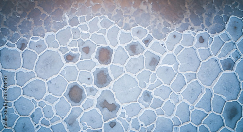 Aerial View of Hexagonal Salt Crust Patterns on Flat Surface
