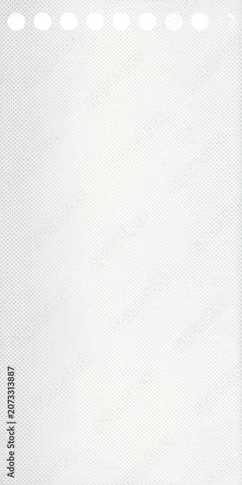 Fototapeta premium Blank white dotted paper texture with perforated top edge