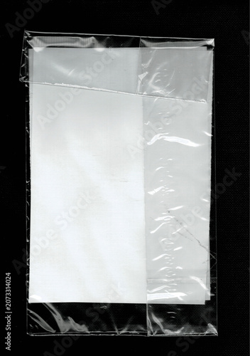 White paper inside a clear plastic sleeve with folded top