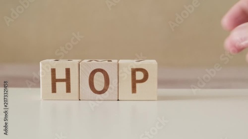 motivational word hope, laying out  by hand from letters on wooden cubes, slow motion
