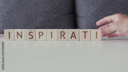 motivational word inspiration, laying out  by hand from letters on wooden cubes, slow motion
