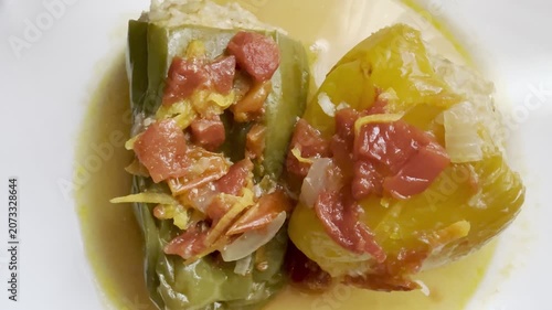 Bell peppers stuffed with meat and rice, stewed in tomato sauce. Delicious and healthy home cooking.