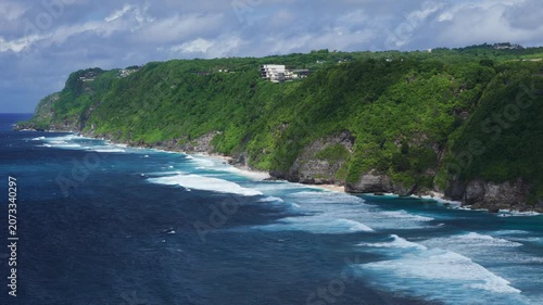 Scenic landscape with cliffs on tropical coastline with ocean and waves. Drone view, travel destination