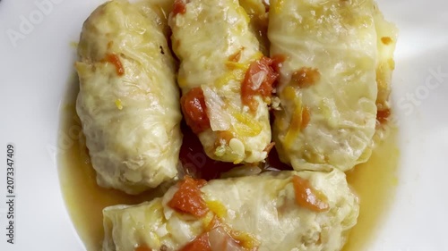 Cabbage rolls stewed in tomato sauce, cabbage leaves stuffed with meat and rice. Delicious and healthy home cooking.