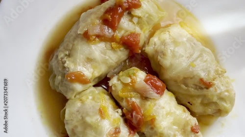Cabbage rolls stewed in tomato sauce, cabbage leaves stuffed with meat and rice. Delicious and healthy home cooking.