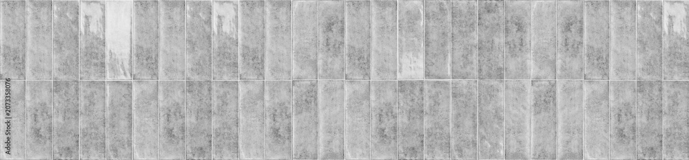 Fototapeta premium Gray weathered ceramic tiles arranged in a vertical running bond layout