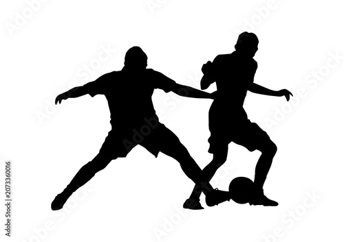 фотографія Silhouette of two soccer players tackling and fighting for the ball