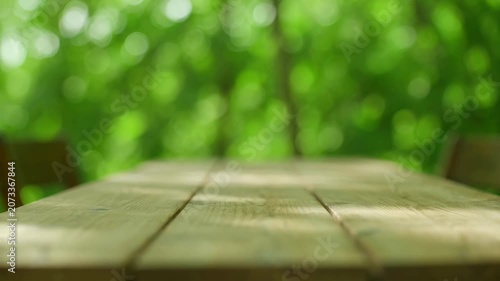 Empty Wooden Table Outdoors with Blurred Green Forest Background for Product Display