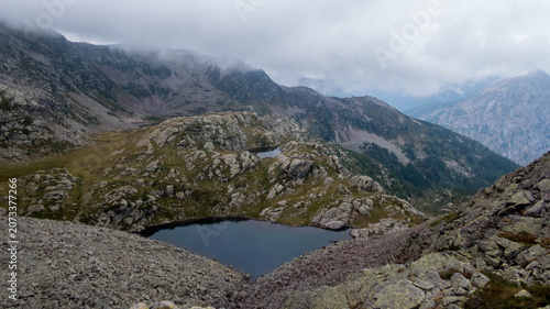 Tschawinersee mountain lake in the Swiss Alps near Val Bognanco border on a cloudy day.