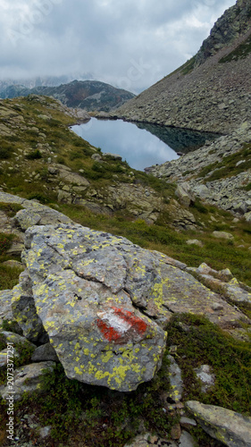 Tschawinersee mountain lake in the Swiss Alps near Val Bognanco border on a cloudy day.