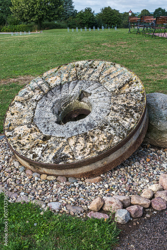 Close-up of an old millstone in front of the old mill in Klütz.