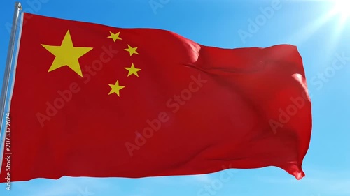 Vibrant Chinese flag waving proudly against a clear blue sky with bright sun.
