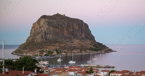 Panoramic Sunset View of the Historic Rock of Monemvasia seen at sunset from the opposite coast. Laconia, Peloponnese, Greece