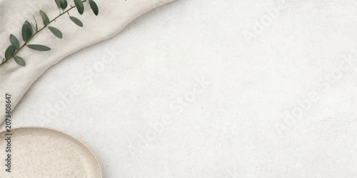 Cuadro en lienzo Minimalist composition with green foliage and beige fabric on textured stone sur