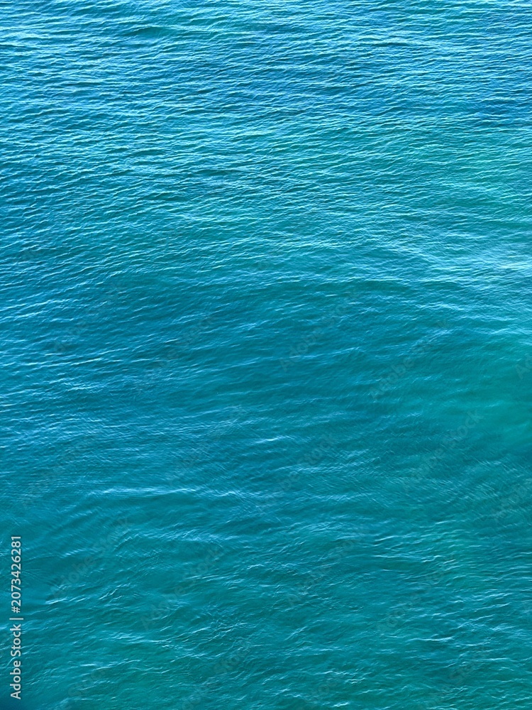 Fototapeta premium Blue sea water ripples vertical