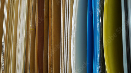 Vertical samples of wooden veneers and colorful plastic sheets