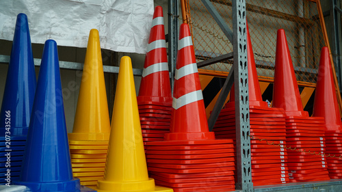 Colorful traffic cones in stacks at an industrial warehouse