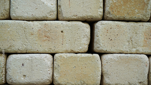 Neat stack of cream colored rectangle adobe bricks