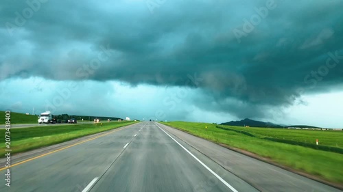 Storm approaching seen from car driving toward dark clouds and bad weather