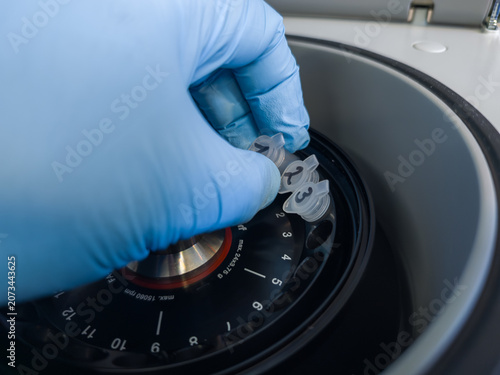 Brussels, Belgium. Loading labeled DNA extraction microcentrifuge tubes into a laboratory centrifuge