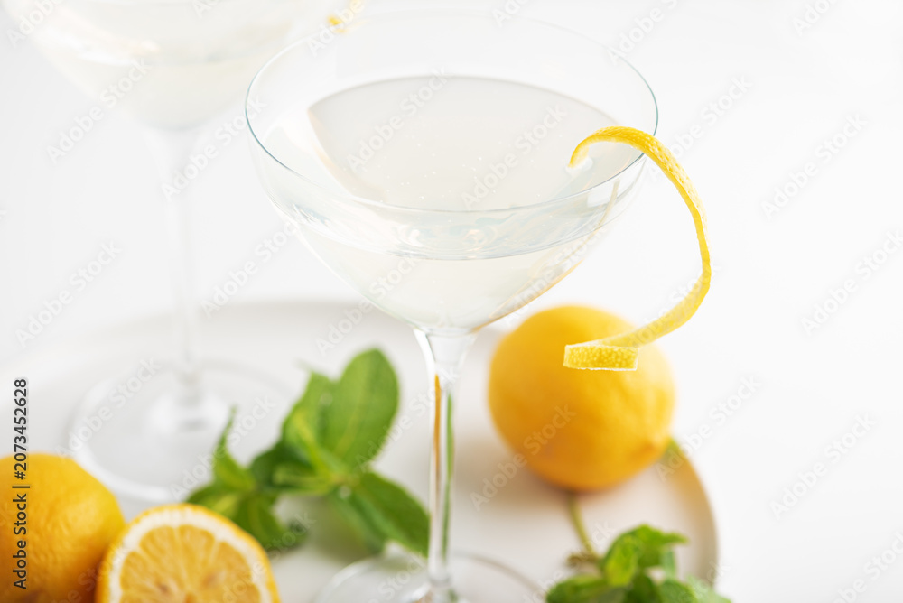 Fototapeta premium Citrus cocktail with lemon twist and fresh mint