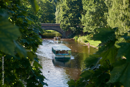 Small sightseeing boat on a Picturesque City Canal in summer Riga, Latvia