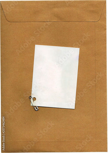 Blank white tag pinned to brown paper envelope