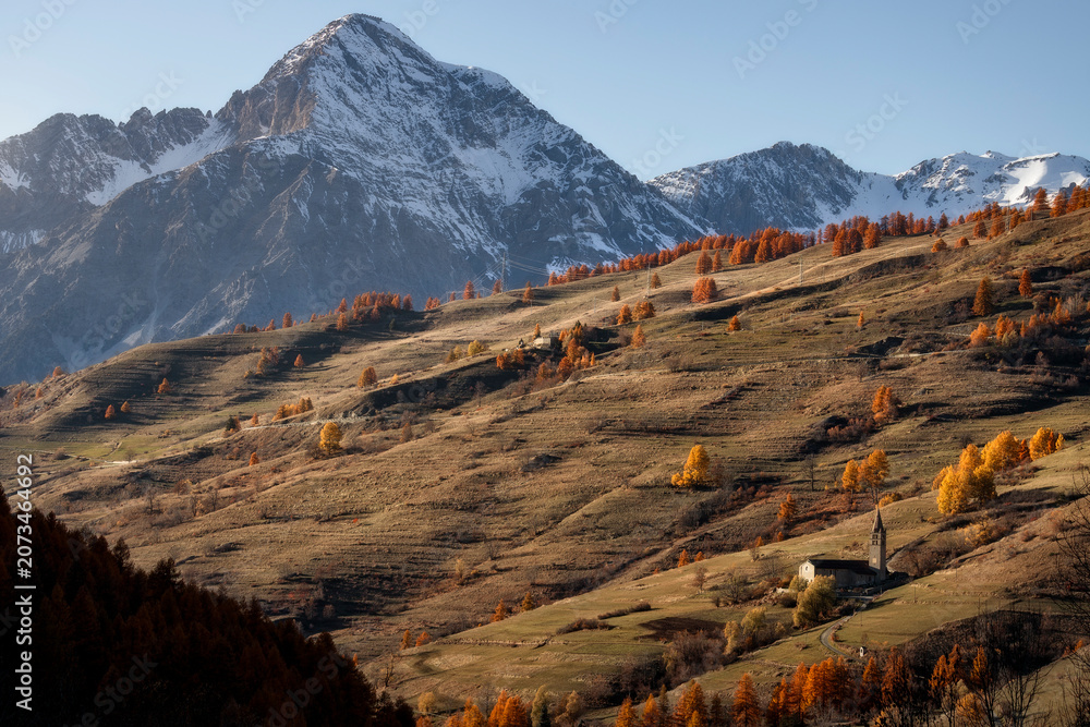Εκτύπωση καμβά Historic San Restituto church in Sauze di Cesana surrounded by autumn foliage wi